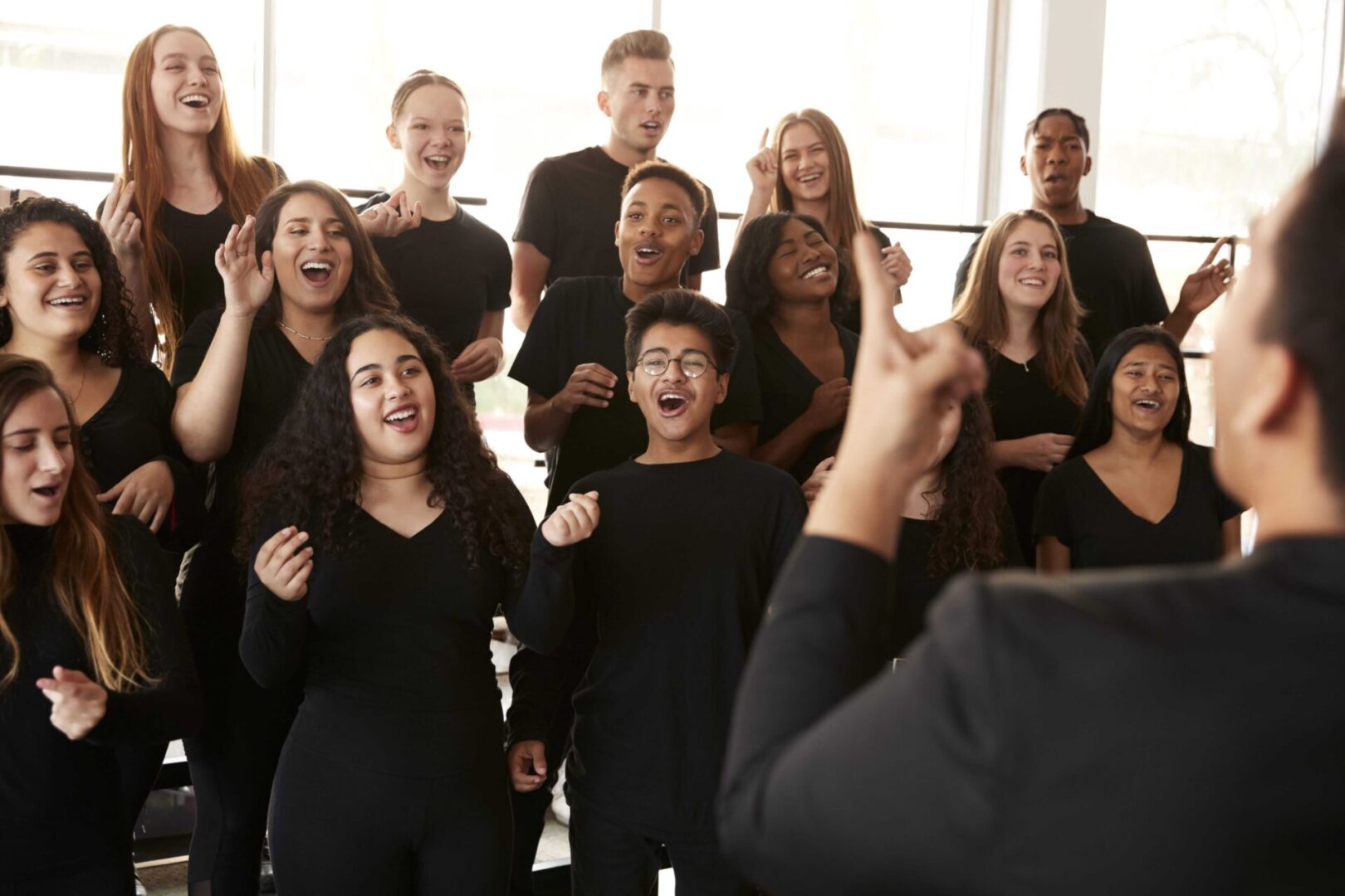 Choir singing under conductor's guidance.
